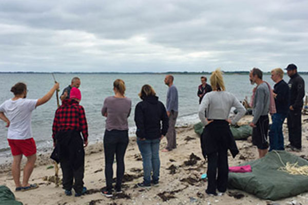 Students standing on beach in Denmark