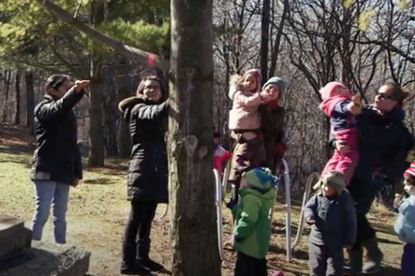 adult teachers with young children outside