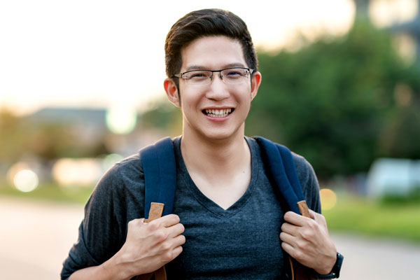 Person smiling with backpack