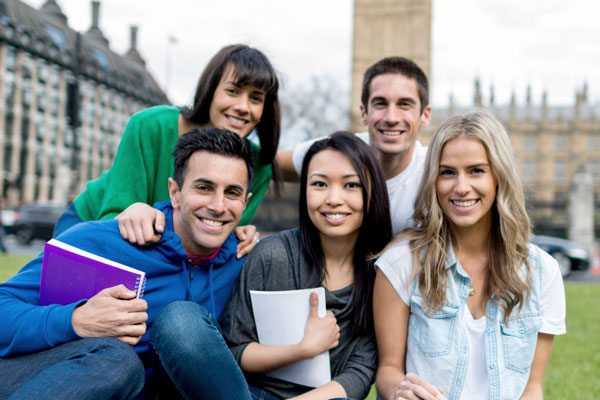 Five students smiling in front of Big Ben tower in England