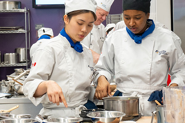 two students cooking