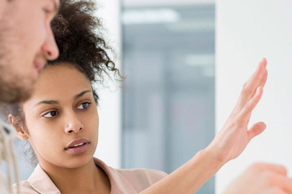 two people looking at a board