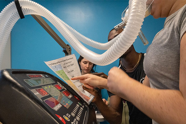 person wearing a mask on the treadmil
