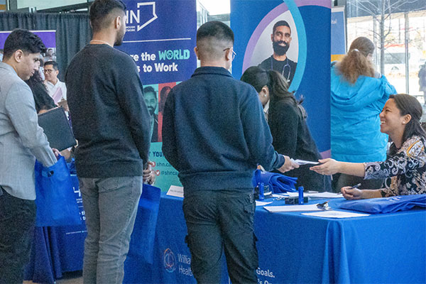 people talking at a booth