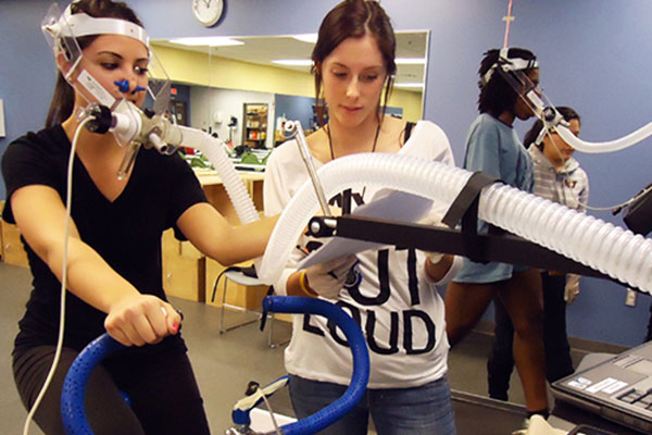student on bike all hooked up with respiratory gear