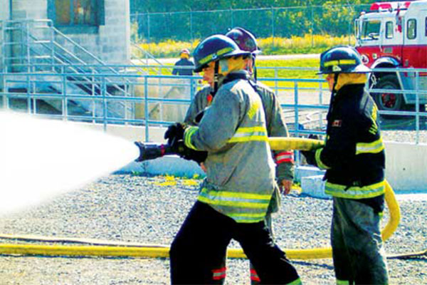 firefighters holding a hose