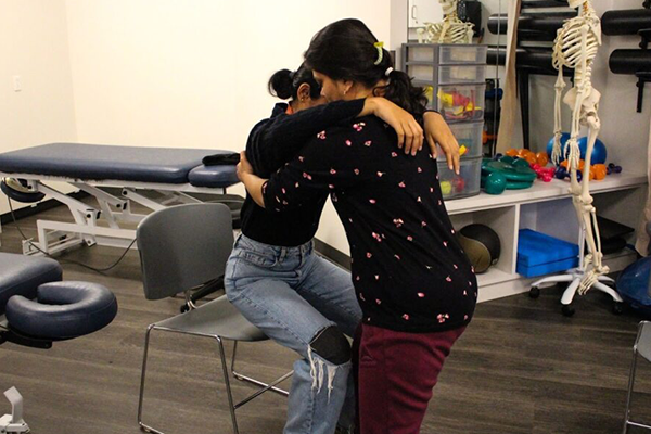 Massage Therapy student Sapna Patel practicing techniques to safely transfer clients to and from their seat