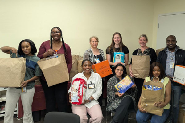 Nursing students holding bags of goods to give to families