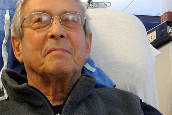 older man laying on hospital bed