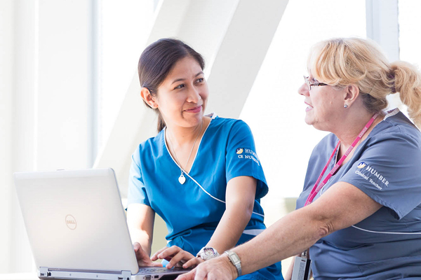 2 female nurses sitting and talking