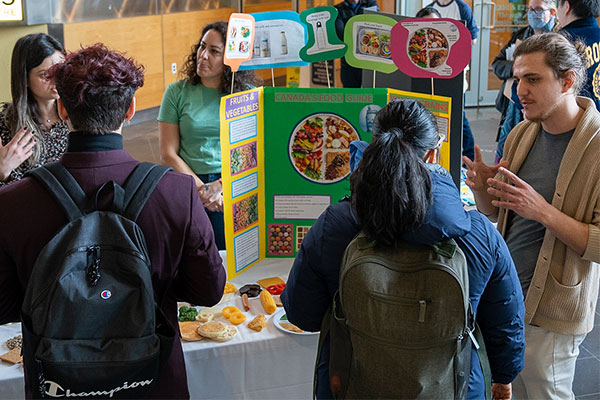 people standing at a booth