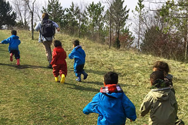 children running up a hill