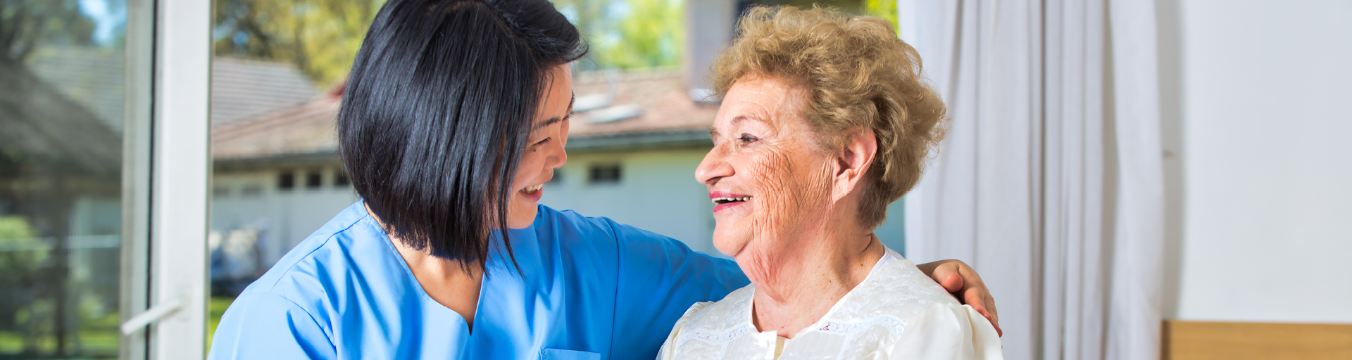 nursing talking with older female patient