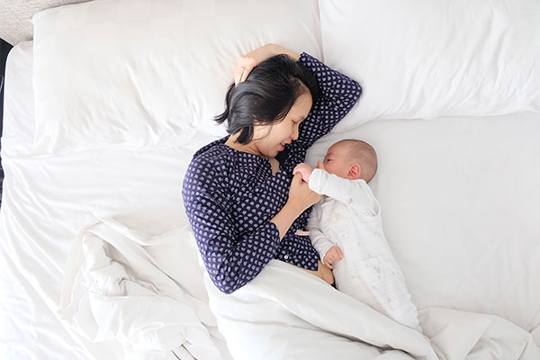 woman with baby on bed