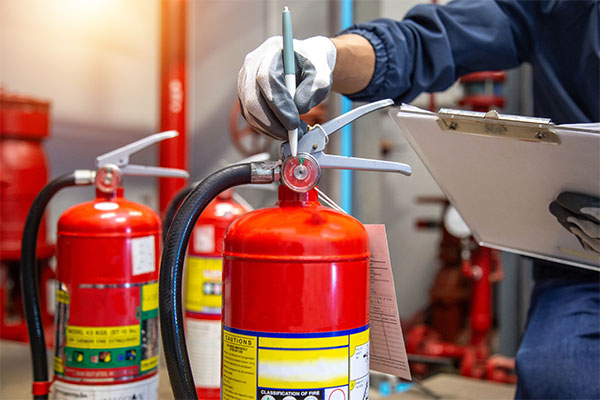 Person inspecting fire extinguisher