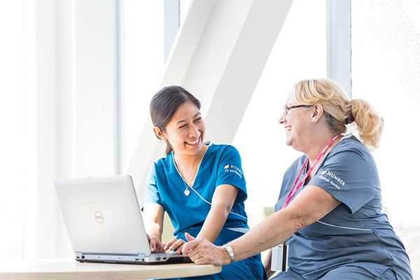 Nursing student and instructor smiling