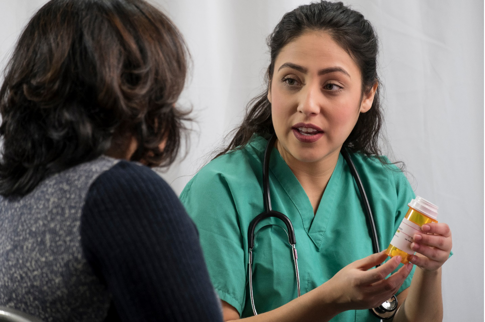 A nurse explaining a medication to a patient