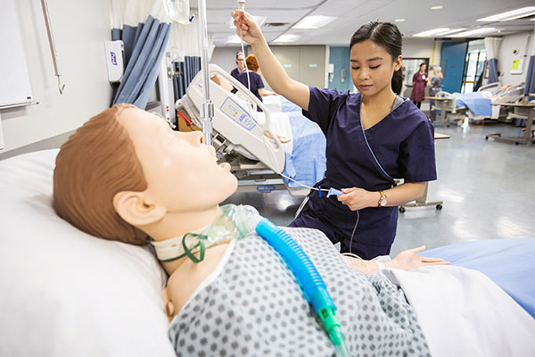 female nursing student administering iv to a dummy
