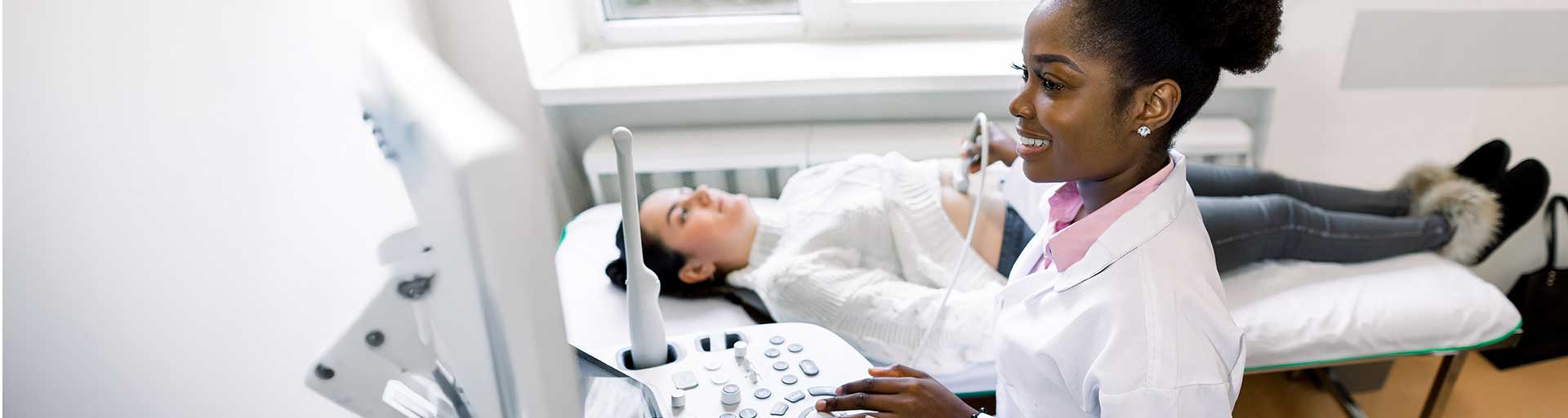 Healthcare professional performing an ultrasound scan on a patient