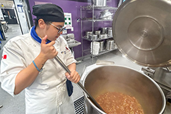 student making soup