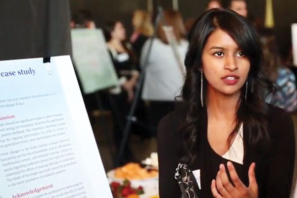 female student discussing her work
