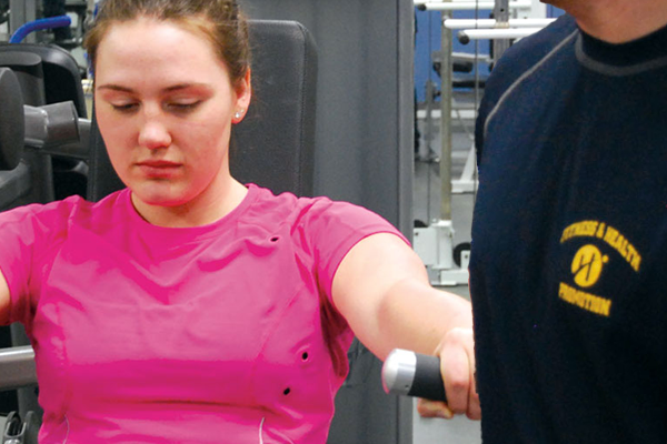 person using a weight machine