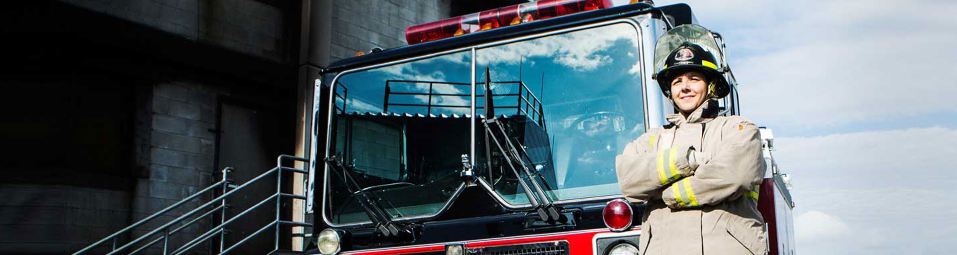 firefighter standing in front of a fire truck