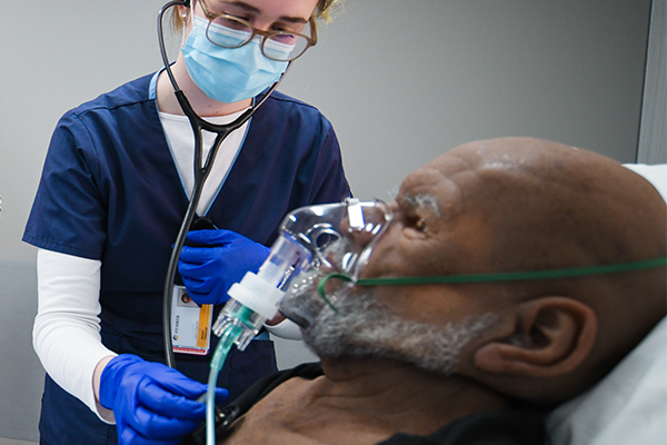 Student nurse using stethoscope