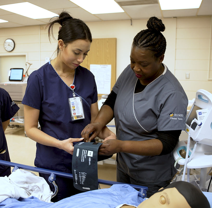 nursing student working with a teacher