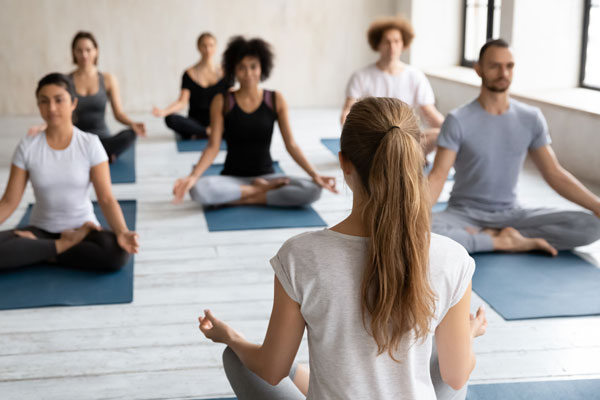 People sitting on yoga mats