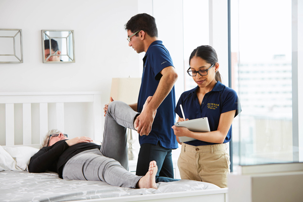 Two physical therapist students treating patient