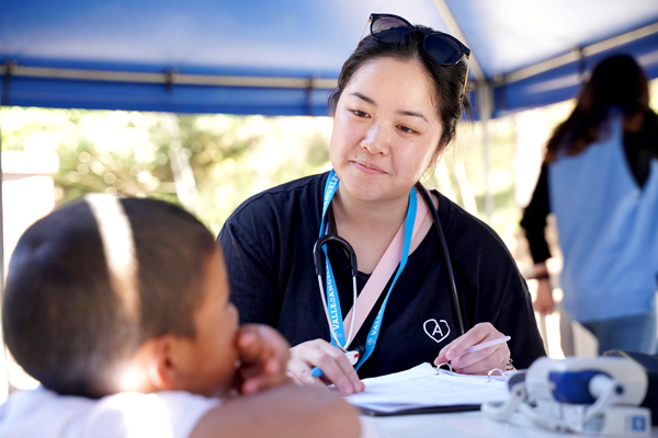 Nursing student talking to child